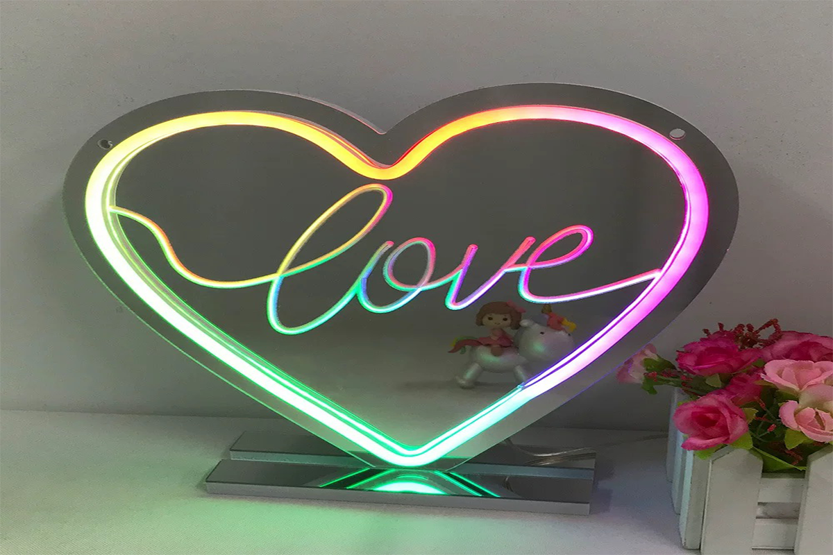 An LED Neon Light Sign in the shape of a heart displays the word 'love,' adding a vibrant touch to any decor