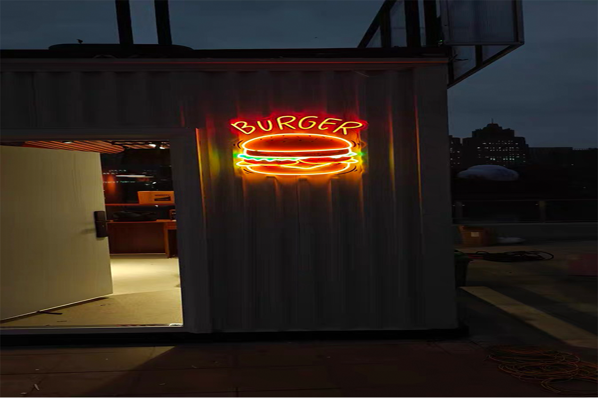 Illuminated burger neon sign with BURGER text and a colorful burger graphic